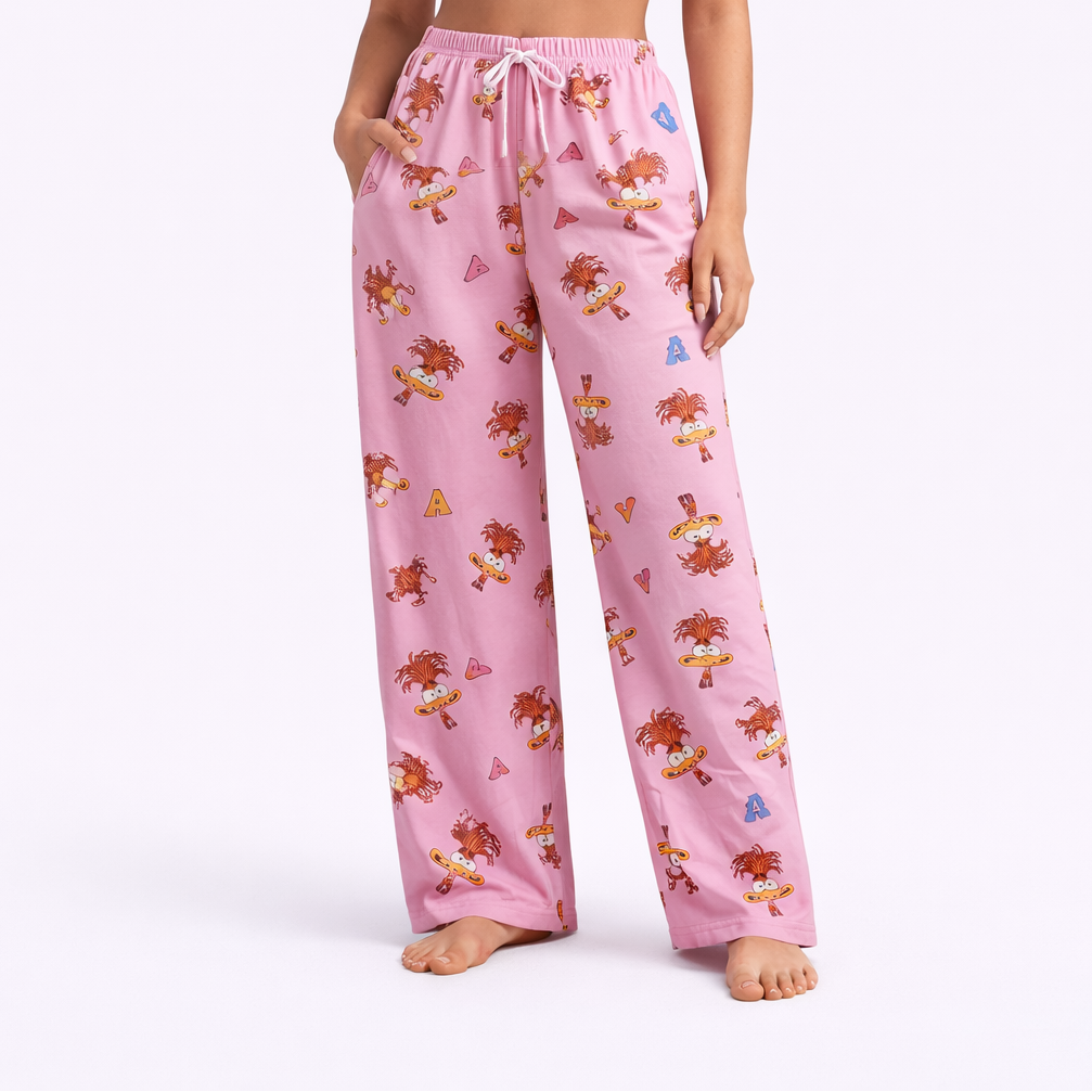 Woman wearing a white strapless top and pink floral pajama pants on a white background